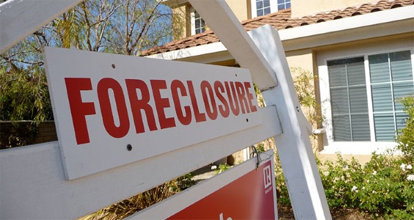 Rates and lending fees for homeowners in foreclosure can be astronomical. A foreclosure sign on the lawn of a property going up for sheriff sale.